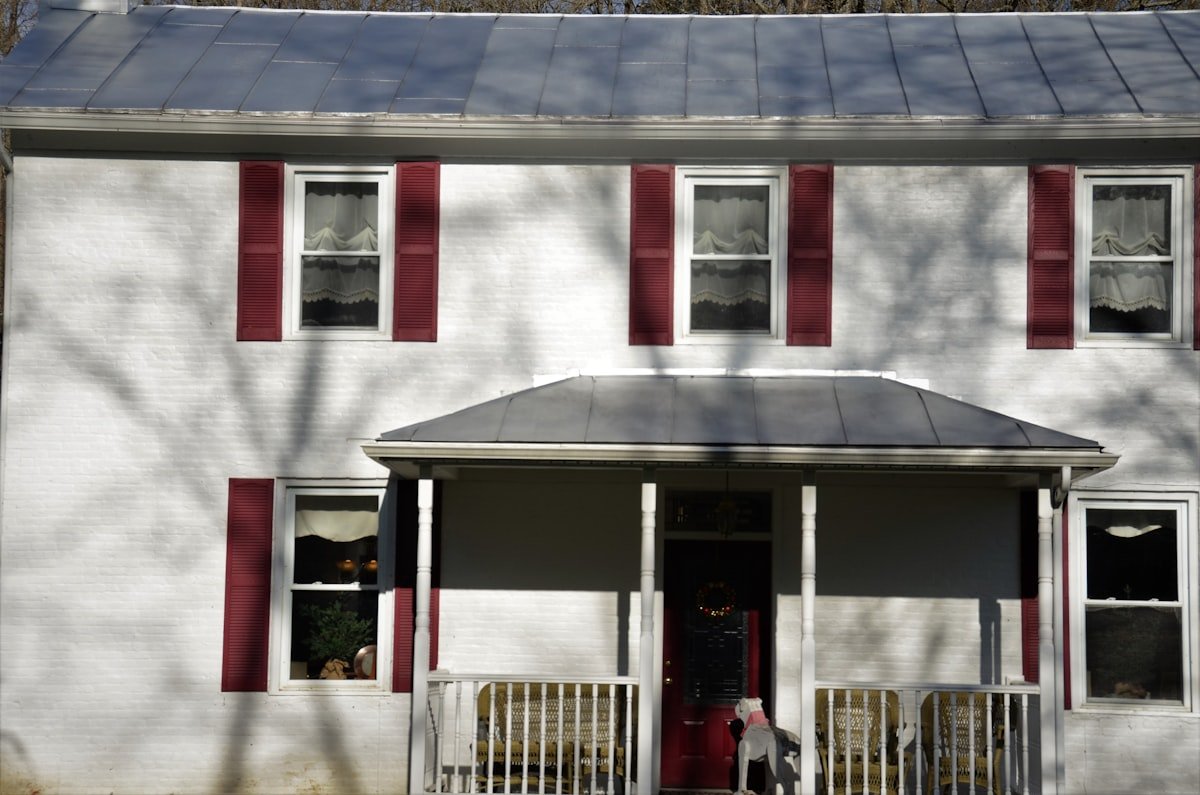 FBI raids former national security advisor John Boltonâ€™s Maryland home - Old 2 story brick house with red trim