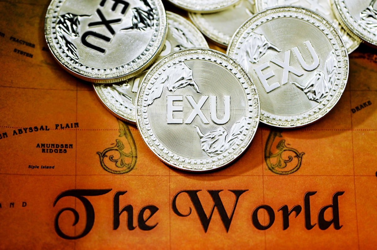 Mastercard and Worldpay team to streamline UAE money movement - A pile of EXU coins on top of a map
