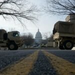 Six Republican states send 1,100 troops to US capital amid crackdown - National Guard trucks parked on the street near the US Capitol.