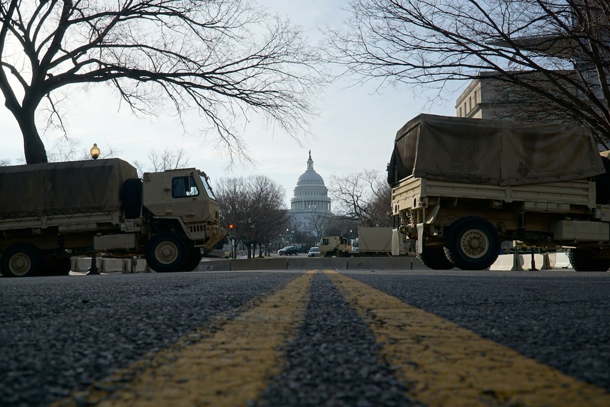 Six Republican states send 1,100 troops to US capital amid crackdown - National Guard trucks parked on the street near the US Capitol.