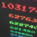US Stock Market Today: Microsoft, Meta earnings lift Nasdaq to a record level - Arcade machine high score board in a rainbow pattern.